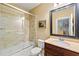 This bathroom boasts a shower and tub with lovely tile work and a framed vanity mirror at 2317 Whiting Bay Courts Nw, Kennesaw, GA 30152