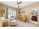 This delightful Bedroom features a charming crib, a cozy chair, and a window overlooking the yard at 2317 Whiting Bay Courts Nw, Kennesaw, GA 30152