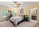 Comfortable bedroom features a well lit study area, neutral walls, and an ensuite bathroom at 2317 Whiting Bay Courts Nw, Kennesaw, GA 30152