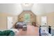 Cozy bedroom with sloped ceilings, bean bag and crib at 2317 Whiting Bay Courts Nw, Kennesaw, GA 30152
