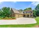 Stunning two-story brick home featuring a three-car garage, well-manicured lawn, and lush landscaping at 2317 Whiting Bay Courts Nw, Kennesaw, GA 30152