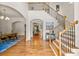 Elegant foyer with hardwood floors, staircase with iron railing, and a view of the dining area at 2317 Whiting Bay Courts Nw, Kennesaw, GA 30152