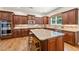 Modern kitchen featuring granite countertops, stainless steel appliances, a center island, and ample cabinet space at 2317 Whiting Bay Courts Nw, Kennesaw, GA 30152