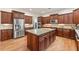 Gourmet kitchen showcasing stainless steel appliances, custom cabinets, and a granite island at 2317 Whiting Bay Courts Nw, Kennesaw, GA 30152