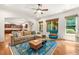 Spacious living room with hardwood floors, comfortable seating, and large windows offering plenty of natural light at 2317 Whiting Bay Courts Nw, Kennesaw, GA 30152