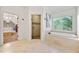Well-lit bathroom featuring large soaking tub, tiled shower and access to walk-in closet at 2317 Whiting Bay Courts Nw, Kennesaw, GA 30152