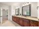 Bathroom with double vanities featuring granite countertops, and decorative mirrors at 2317 Whiting Bay Courts Nw, Kennesaw, GA 30152