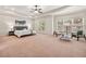 Spacious main bedroom with tray ceilings, ceiling fan, carpet floors and sitting area at 2317 Whiting Bay Courts Nw, Kennesaw, GA 30152