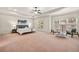 Spacious main bedroom with tray ceilings, ample natural light, and a cozy seating area at 2317 Whiting Bay Courts Nw, Kennesaw, GA 30152