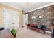Modern office with unique brick accent wall, tan carpet, stylish furniture and decor at 2317 Whiting Bay Courts Nw, Kennesaw, GA 30152