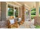 Charming front porch with rocking chairs and stone flooring offers a warm welcome at 2317 Whiting Bay Courts Nw, Kennesaw, GA 30152
