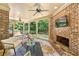 Relaxing sunroom features a stone fireplace, brick walls, and views of the backyard at 2317 Whiting Bay Courts Nw, Kennesaw, GA 30152