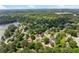 Scenic aerial view showcases a neighborhood nestled among green trees, with houses lining winding streets and lake access at 2979 Overwood Sw Ln, Snellville, GA 30078