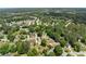 Aerial photograph of a leafy neighborhood with varied houses on meandering streets and generous green spaces at 2979 Overwood Sw Ln, Snellville, GA 30078