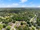 Overhead shot of a green, tree-filled community featuring diverse homes, winding streets, and inviting swimming pools at 2979 Overwood Sw Ln, Snellville, GA 30078