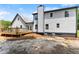 Exterior of home featuring a back deck, manicured lawn, white siding, and dark trim at 2979 Overwood Sw Ln, Snellville, GA 30078