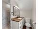 Bright bathroom featuring a shower with beautiful tile and a modern vanity with wood countertop at 2979 Overwood Sw Ln, Snellville, GA 30078
