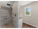 Modern bathroom boasts tiled shower, wood countertop, and window with natural light at 2979 Overwood Sw Ln, Snellville, GA 30078