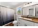 Updated bathroom with modern vanity, sleek fixtures, and a stylish shower curtain at 2979 Overwood Sw Ln, Snellville, GA 30078