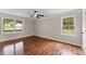 Bright bedroom with hardwood floors, two windows, and neutral paint, creating a serene space at 2979 Overwood Sw Ln, Snellville, GA 30078