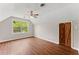 Bedroom with hardwood floors, barn door closet, and window with natural light at 2979 Overwood Sw Ln, Snellville, GA 30078