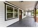 Charming covered front porch with dark wood accents and ample space for seating at 2979 Overwood Sw Ln, Snellville, GA 30078