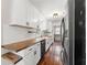 Modern galley kitchen with white cabinets, butcher block countertops, and stainless steel appliances at 2979 Overwood Sw Ln, Snellville, GA 30078