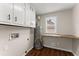 Laundry room features white cabinets, wood countertop, and modern water heater at 2979 Overwood Sw Ln, Snellville, GA 30078