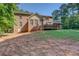 A brick home with a back deck, showcasing a well-maintained lawn and a secluded backyard space at 502 Brookline Pl, Mcdonough, GA 30252