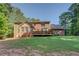 Exterior view of home from the backyard with a deck and manicured lawn at 502 Brookline Pl, Mcdonough, GA 30252
