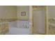 Bright bathroom featuring a shower with gold trim and a separate soaking tub at 502 Brookline Pl, Mcdonough, GA 30252