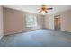 Bedroom with a window and doorway, soft blue carpet, and neutral paint at 502 Brookline Pl, Mcdonough, GA 30252