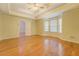Large bedroom with hardwood floors, tray ceilings, and multiple windows for natural light at 502 Brookline Pl, Mcdonough, GA 30252