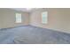 Large carpeted bedroom with natural light and neutral paint at 502 Brookline Pl, Mcdonough, GA 30252