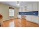 Bedroom features hardwood floors, built-in desk, and cabinets for storage and organization at 502 Brookline Pl, Mcdonough, GA 30252