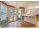 Bright breakfast nook featuring hardwood floors, pendant lighting, and outdoor access at 502 Brookline Pl, Mcdonough, GA 30252