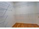Walk-in closet offers ample storage with built-in wire shelving and hardwood floor at 502 Brookline Pl, Mcdonough, GA 30252