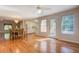 Open concept dining area with hardwood floors, view of kitchen, and natural light at 502 Brookline Pl, Mcdonough, GA 30252