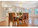 Dining area featuring a chandelier, hardwood floors, and view of kitchen at 502 Brookline Pl, Mcdonough, GA 30252