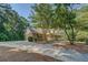 Brick home with a long driveway, a front porch, and well-maintained landscaping, set among mature trees at 502 Brookline Pl, Mcdonough, GA 30252