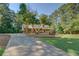 A brick home features a long driveway, a front porch, and well-maintained landscaping, set among mature trees at 502 Brookline Pl, Mcdonough, GA 30252