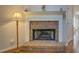 Close up of brick fireplace with white mantel, and hardwood floors at 502 Brookline Pl, Mcdonough, GA 30252