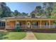 Inviting brick home featuring a covered porch with white columns at 502 Brookline Pl, Mcdonough, GA 30252