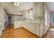 Open kitchen area with white cabinets, hardwood floors, and view of the backyard at 502 Brookline Pl, Mcdonough, GA 30252