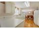 Spacious kitchen with white cabinets, laminate countertops, and an adjacent dining area at 502 Brookline Pl, Mcdonough, GA 30252