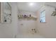 Functional laundry room with vinyl floors, storage shelves, and washer/dryer hookups at 502 Brookline Pl, Mcdonough, GA 30252