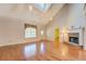 Bright living room featuring hardwood floors, a fireplace, and vaulted ceilings at 502 Brookline Pl, Mcdonough, GA 30252
