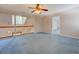 Open loft area featuring soft blue carpet, wood railing, and a lighted ceiling fan at 502 Brookline Pl, Mcdonough, GA 30252