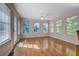 Bright sunroom featuring hardwood floors, white trim, and multiple windows for natural light at 502 Brookline Pl, Mcdonough, GA 30252