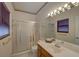 Bright bathroom with a vanity, mirrored wall, and a glass-enclosed shower at 1453 Cambridge Cmn, Decatur, GA 30033